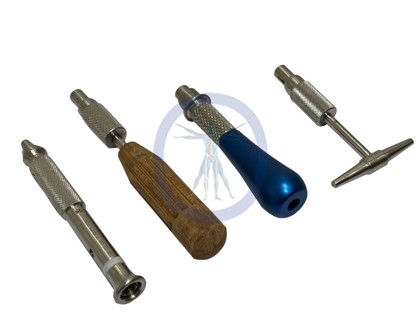 A set of five different tools are laying on the ground.