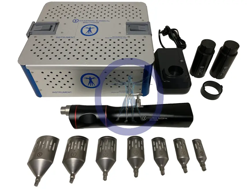 A surgical saw and accessories on a blue table.