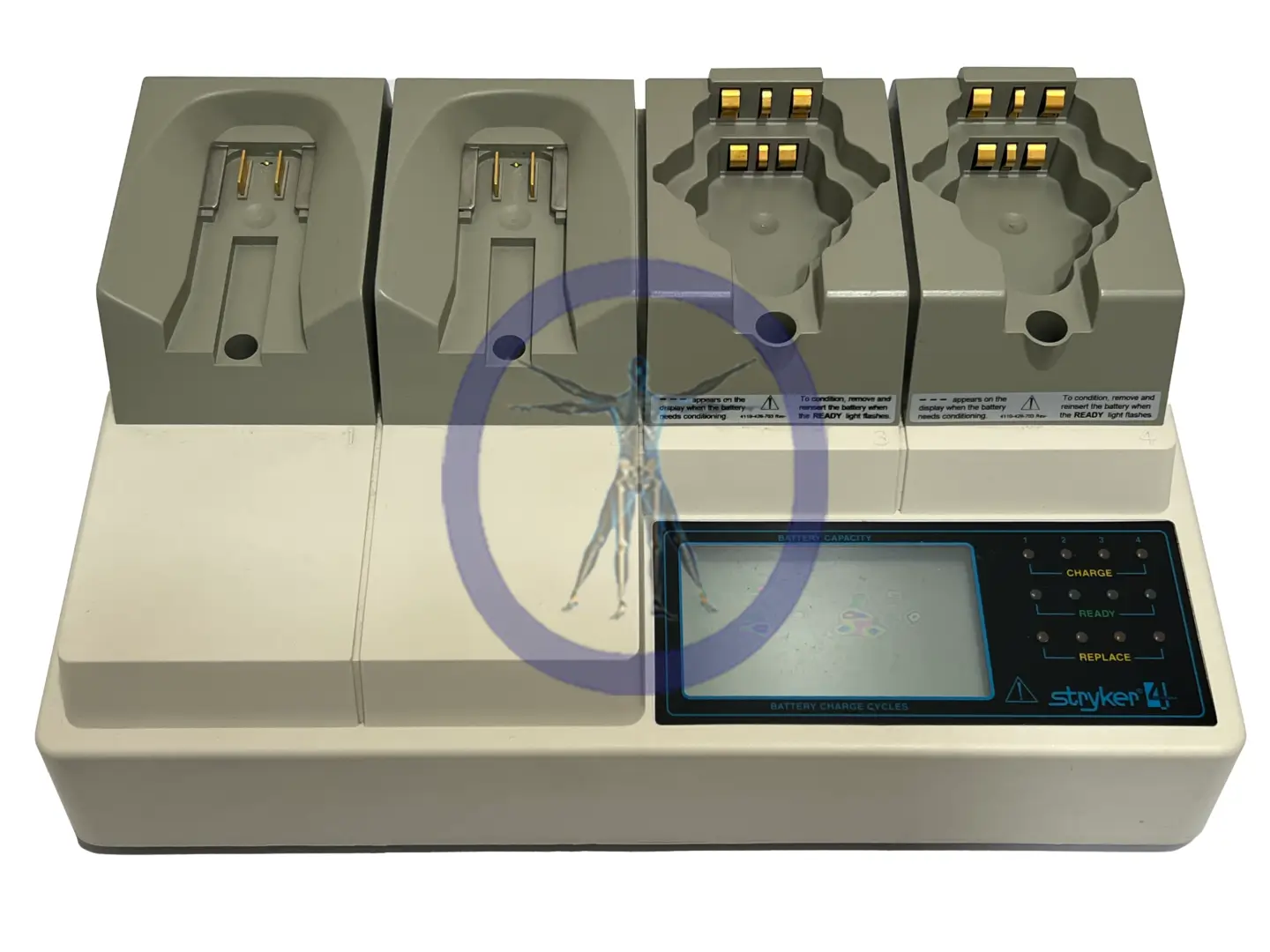A Stryker System 4 & 5 4110-120 Universal Battery Charger with three docks, displaying a status screen and a small figurine placed on it.