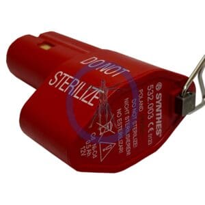 A red sterile container with a metal clip attached to it.