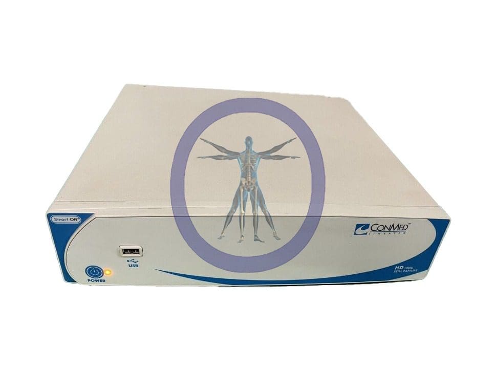 White medical device labeled ConMed VP1600 HD 1080p Digital Image Capture System with a symbol of a human in a circle on its top, featuring several ports and buttons on the front panel.